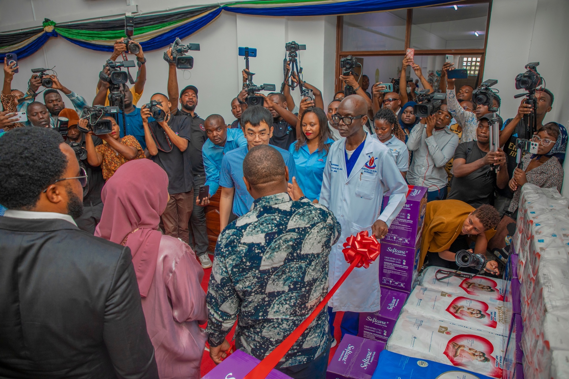 Zari Hassan and partners at a hospital ribbon cutting surrounded by press and photographers